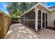 This charming screened-in back porch features a brick patio and leads to a fenced-in backyard, perfect for outdoor gatherings at 1034 Steelechase Ln, Hanahan, SC 29410