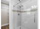 Modern glass enclosed walk-in shower with white subway tiles and mosaic accents leading to the closet at 1034 Steelechase Ln, Hanahan, SC 29410