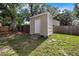 This backyard features a shed with a single door, surrounded by trees and grass, offering practical storage space at 1034 Steelechase Ln, Hanahan, SC 29410