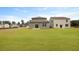 View of backyard featuring a large lawn, gray siding, and neighboring homes in the community at 1035 Forrest Creek Dr, Summerville, SC 29483