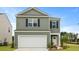 Attractive two-story home with a two-car garage, black shutters, and a well-kept lawn under a clear sky at 1035 Forrest Creek Dr, Summerville, SC 29483