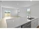 Bright, open-concept kitchen featuring an island with sink and dishwasher, flowing into the living area at 1035 Forrest Creek Dr, Summerville, SC 29483