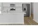 Modern kitchen with white cabinets, stainless steel appliances, a center island, and wood flooring at 1035 Forrest Creek Dr, Summerville, SC 29483