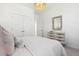 Bedroom with a modern dresser, an ornate mirror, and double closets, illuminated by a decorative pendant at 1051 Scotch Bonnet Way, Summerville, SC 29485