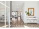 Welcoming entryway showcasing wood floors, a decorative mirror, and views into the living spaces at 1051 Scotch Bonnet Way, Summerville, SC 29485