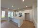 Bright kitchen boasts a large center island, white cabinets, and modern stainless-steel appliances at 1051 Scotch Bonnet Way, Summerville, SC 29485