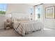 Bright main bedroom featuring plush carpet, large windows, stylish lamps, and a decorative tufted headboard at 1051 Scotch Bonnet Way, Summerville, SC 29485
