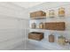 Well-organized pantry with wire shelving, filled with baskets and glass jars for optimal storage space at 1051 Scotch Bonnet Way, Summerville, SC 29485