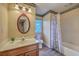 Bathroom with vanity, cherry wood cabinet, mirror, and shower with tub at 106 Cicero Ct, Goose Creek, SC 29445