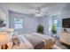 Stylishly staged bedroom with ceiling fan, hardwood floors, modern furnishings, and ample natural light at 106 Cicero Ct, Goose Creek, SC 29445
