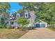 View of home with a detached two-car garage and a long driveway at 106 Cicero Ct, Goose Creek, SC 29445