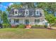 Charming two-story home with a welcoming front porch, manicured lawn and mature trees at 106 Cicero Ct, Goose Creek, SC 29445