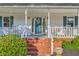 Inviting front porch with rocking chairs and a welcome pineapple on the front door at 106 Cicero Ct, Goose Creek, SC 29445