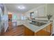 Beautiful kitchen with stainless steel refrigerator, breakfast bar, and wood flooring at 106 Cicero Ct, Goose Creek, SC 29445