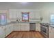 Spacious kitchen has stainless steel dishwasher and range with white cabinets at 106 Cicero Ct, Goose Creek, SC 29445