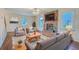 Cozy living room boasts fireplace, ceiling fan, hardwood floors, and natural light at 106 Cicero Ct, Goose Creek, SC 29445