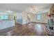 Bright living room features an open floor plan, brick fireplace and hardwood flooring at 106 Cicero Ct, Goose Creek, SC 29445