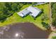Stunning lakefront property boasting a well-manicured lawn and a charming residence with metal roof at 110 Huntington Ct, Walterboro, SC 29488