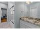 Bathroom boasts granite countertop, white vanity and large mirror, and a shower through the doorway at 110 Huntington Ct, Walterboro, SC 29488