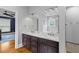 Bathroom featuring a double vanity, hardwood floors, and a view of the soaking tub at 110 Huntington Ct, Walterboro, SC 29488