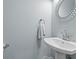 Stylish powder room featuring pedestal sink, decorative mirror and gray walls at 110 Huntington Ct, Walterboro, SC 29488