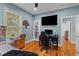 Bedroom features a full-sized bed, desk, TV, wood floors, and lots of natural light at 110 Huntington Ct, Walterboro, SC 29488