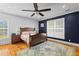 Comfortable bedroom with hardwood floors, ceiling fan, and natural light from two windows at 110 Huntington Ct, Walterboro, SC 29488