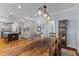 Open-concept design with the kitchen flowing into the dining space, featuring a rustic wooden table at 110 Huntington Ct, Walterboro, SC 29488