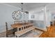 Inviting dining area features a wooden table, complementary bench, and rustic light fixture at 110 Huntington Ct, Walterboro, SC 29488
