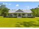 Lovely single-Gathering home with a metal roof, covered front porch, and a well-maintained green lawn at 110 Huntington Ct, Walterboro, SC 29488