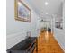 Hallway featuring hardwood floors, wainscoting, and an open view into the kitchen and living areas at 110 Huntington Ct, Walterboro, SC 29488