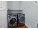Laundry room with modern washer and dryer, white shelving and white walls looks spacious at 110 Huntington Ct, Walterboro, SC 29488