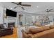 Bright living room features a fireplace, hardwood floors, and access to a screened porch at 110 Huntington Ct, Walterboro, SC 29488