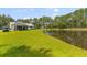 Landscaped lawn that leads to a pond, trees, and home at 110 Huntington Ct, Walterboro, SC 29488