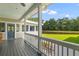 Inviting covered porch with views of the backyard, trees, and pond at 110 Huntington Ct, Walterboro, SC 29488