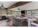 Cozy sun room with a fireplace, exposed wood beams, and a built-in bar area at 110 Huntington Ct, Walterboro, SC 29488