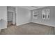 Bright bedroom featuring neutral walls, carpet flooring, and two large windows at 110 True Blue Lp, Summerville, SC 29486