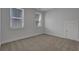 Empty bedroom with neutral carpet, two windows, white walls, and a door at 110 True Blue Lp, Summerville, SC 29486