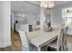 Bright dining room with modern lighting, an open concept kitchen, and neutral tones create a warm inviting space at 110 True Blue Lp, Summerville, SC 29486