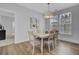 Charming dining room with seating for six, wood-look floors, modern lighting, and serene decor at 110 True Blue Lp, Summerville, SC 29486