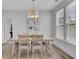 Light-filled dining room with seating for six, modern lighting, and a view to the outdoors at 110 True Blue Lp, Summerville, SC 29486