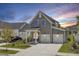 Beautiful two-story gray home with blue shutters, a welcoming porch, and a two-car garage at 110 True Blue Lp, Summerville, SC 29486