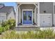 A charming home featuring a blue double-door entry, three steps up to the doorway, and manicured landscaping at 110 True Blue Lp, Summerville, SC 29486
