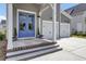Charming home with eye-catching blue double-door entry, steps to the doorway, with manicured landscaping at 110 True Blue Lp, Summerville, SC 29486