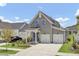 Charming two-story home features a three-car garage and manicured lawn at 110 True Blue Lp, Summerville, SC 29486