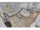 Open-concept living room with a view of the kitchen, dining area, modern furniture, and natural light at 110 True Blue Lp, Summerville, SC 29486