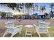 Community playground area with chairs, swings and slides for outdoor enjoyment and recreation at 110 True Blue Lp, Summerville, SC 29486