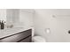 Bathroom with brown cabinets, sink, toilet, and white walls, featuring a vanity mirror at 113 Jackson Pond Ct, Summerville, SC 29486