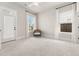 Sunlit bedroom showcasing soft carpet, bright windows, and an outdoor access door at 113 Jackson Pond Ct, Summerville, SC 29486