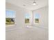 Bright bedroom with three windows offering neighborhood views and a neutral carpet at 113 Jackson Pond Ct, Summerville, SC 29486